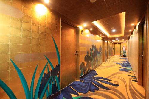 a hallway with a painting on the wall at Centurion Hotel Grand Akasakamitsuke Station in Tokyo