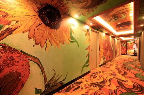 a hallway with a mural of a sunflower on the wall at Centurion Hotel Grand Akasakamitsuke Station in Tokyo