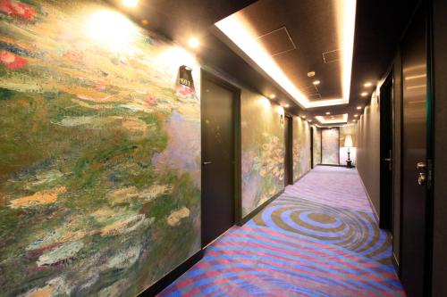 a hallway with a large painting on the wall at Centurion Hotel Grand Akasakamitsuke Station in Tokyo