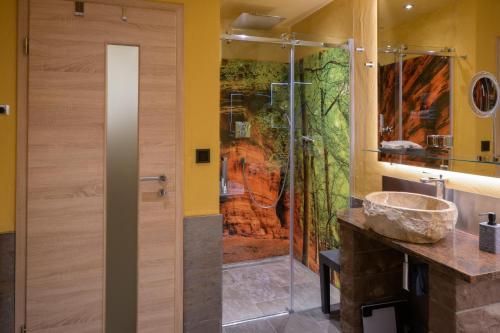 a shower with a glass door in a bathroom at Ferienwohnung Altschloss in Eppenbrunn