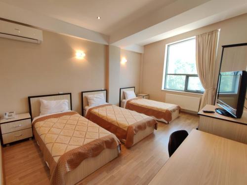 A bed or beds in a room at Gabala Qoruq Resort