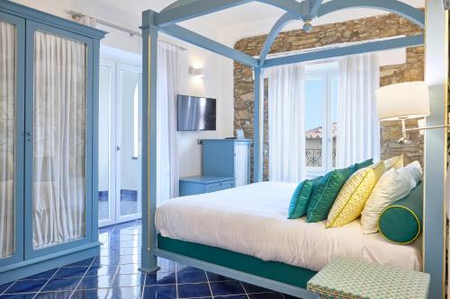 a bedroom with a bed with a blue frame at Palazzo Gentilcore in Castellabate
