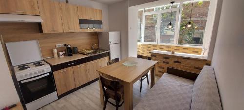 a small kitchen with a table and a stove top oven at Apartment Jasmin in Tsarevo