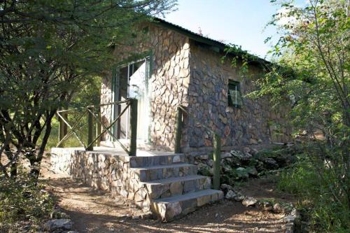 a stone house with stairs leading up to it at Sasa Safari Camp & Tours in Outjo
