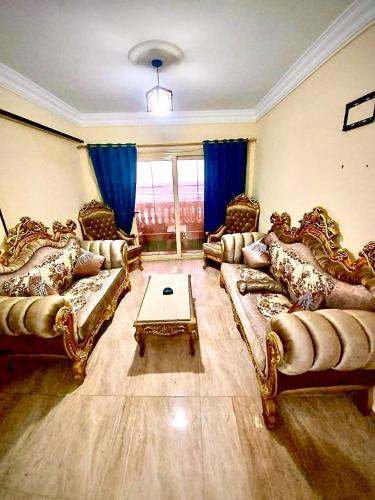 a large living room with couches and a table at شقة بأطلالة علي الشاطئ in Alexandria