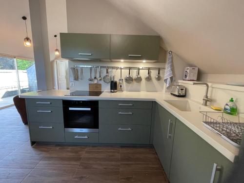 a kitchen with a sink and a stove top oven at the Parc Place in Sarlat-la-Canéda