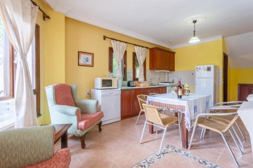 a kitchen and living room with a table and chairs at BG Villas & Aparts in Kas