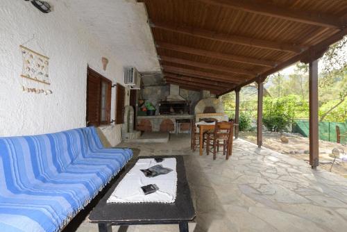 a living room with a blue couch and a table at Marin Holiday in Dhaskalión