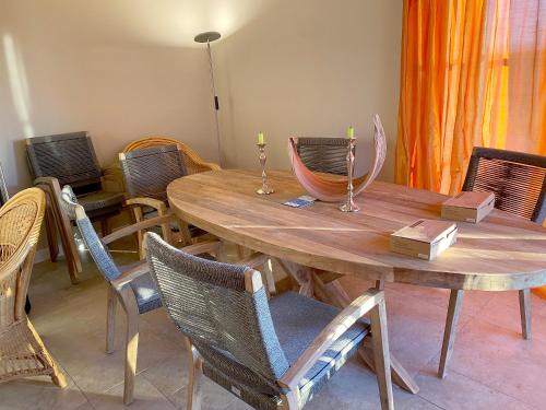 a wooden table and chairs with candles on it at Premium Ferienhaus Söss Diek in Groß Schwansee in Kalkhorst