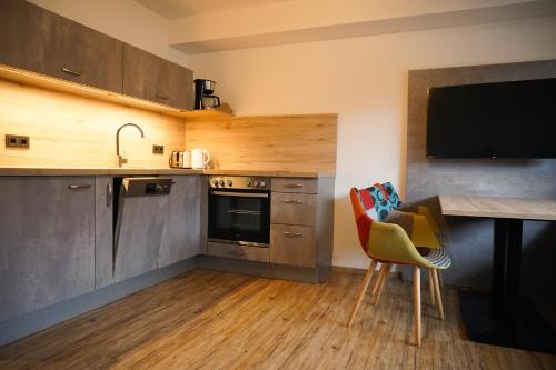 a kitchen with a sink and a table and a counter at Hotel verWeiler in Fischen
