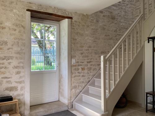 a staircase in a home with a window at La Closerie de Gigny Maison Templiere avec Piscine,jacuzzi in Gigny
