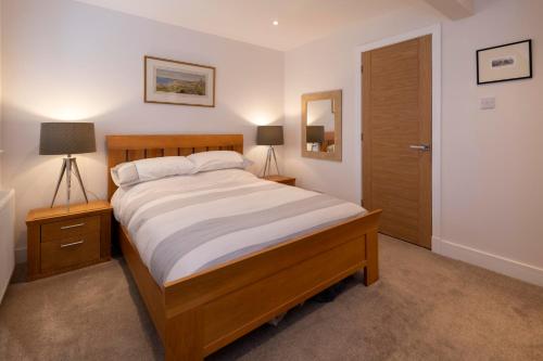 sypialnia z łóżkiem, 2 lampkami i drzwiami w obiekcie No. 7 Glamaig Place w mieście Portree