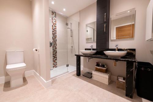 a bathroom with two sinks and a shower at No. 7 Glamaig Place in Portree