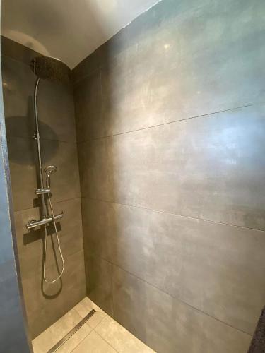 a shower stall in a bathroom with a wall at L'Eté sans fin, vue mer in Filaos