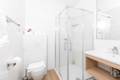 a bathroom with a shower and a toilet and a sink at Stella Mare Eco Boutique House in Zavala