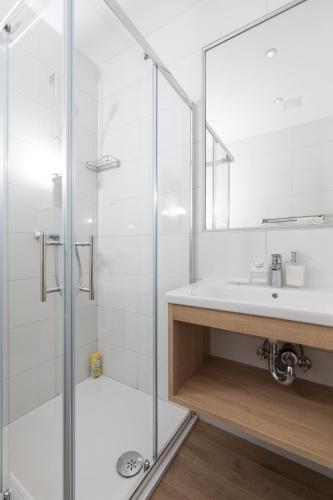 a bathroom with a glass shower and a sink at Stella Mare Eco Boutique House in Zavala