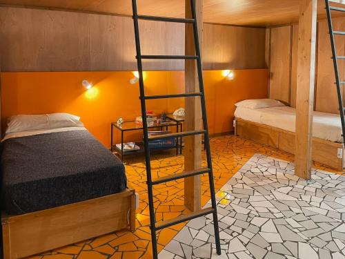 a bedroom with two bunk beds and a ladder at NAP Hostel Spaccanapoli in Naples