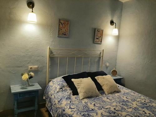 a bedroom with a bed with two pillows on it at CASA RURAL "ECCEHOMO de BORJA" in Borja