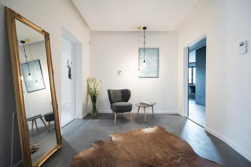 uno specchio in un soggiorno con sedia e tavolo di Premium Apartment for Old Town & Jewish Quarter plus Pool a Cracovia
