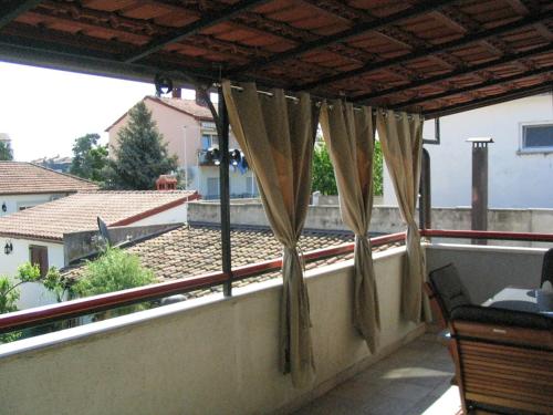 a balcony with a view of a house at Apartment Dady with a large covered terrace in Fažana