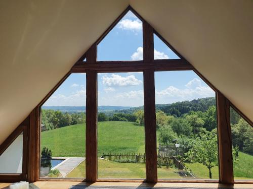a window with a view of a green field at Sunrise Retreat in Bad Blumau
