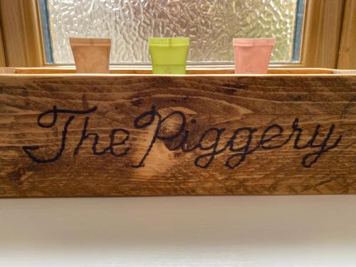 a wooden tray with three different colored drinks on it at The Piggery at the Cottage in Wool