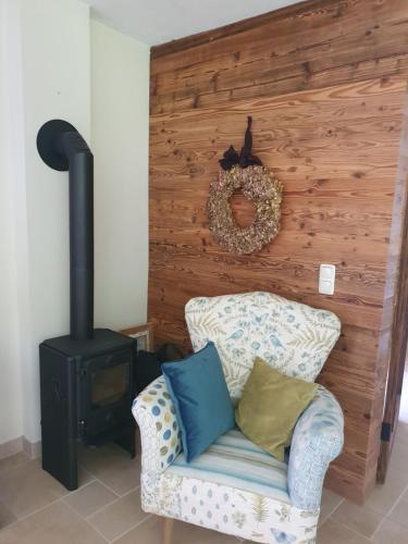 a living room with a chair and a stove at Sunrise Retreat in Bad Blumau