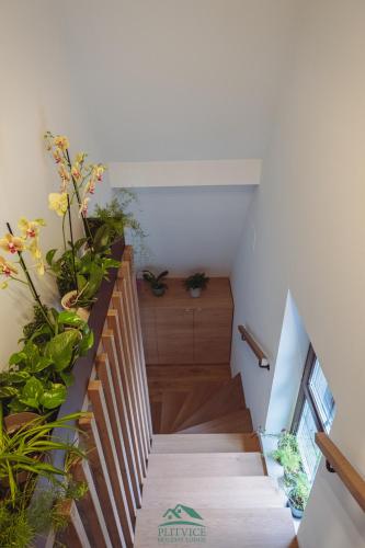a staircase with potted plants in a room at B&B Plitvice Holiday Lodge in Plitvička Jezera
