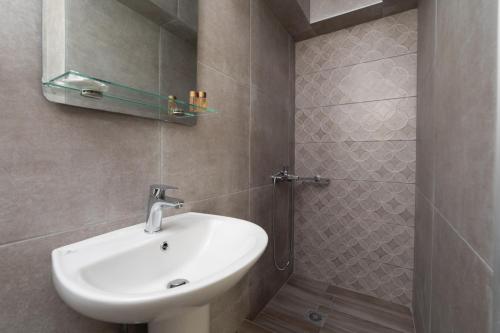 a bathroom with a sink and a shower at Fani Guesthouse in Paralia Katerinis