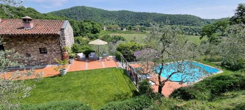 an external view of a house with a swimming pool at Relais I Due Roccoli in Iseo