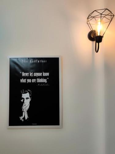 a poster on a wall next to a light at Procida Hostel by Vibe Village in Pune