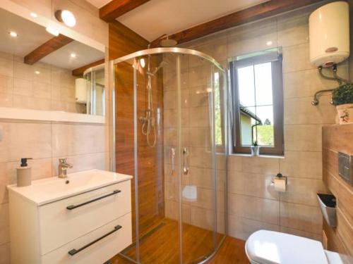 a bathroom with a shower and a sink at Domki U Tadzia 603-425-844 in Polańczyk