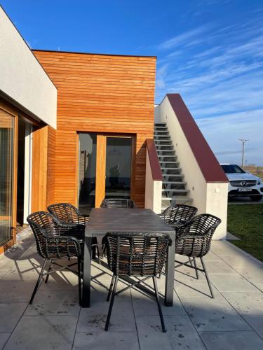 a table and chairs on a patio with a house at Apartmán Pálavská Brána in Brod nad Dyjí