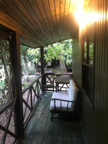 a porch of a house with a white couch on it at Kibala Hotel in Cıralı