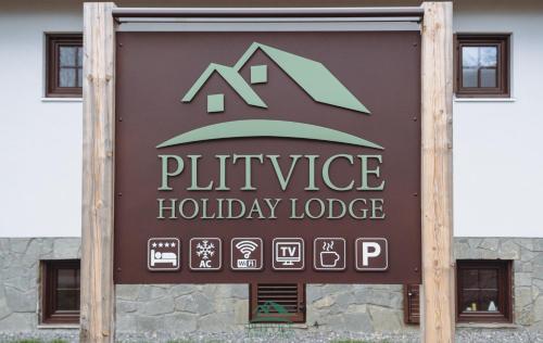 a sign for a physics holiday lodge in front of a building at B&B Plitvice Holiday Lodge in Plitvička Jezera
