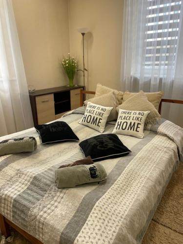 a bed with pillows on it in a bedroom at Apartament "Marka" in Piła