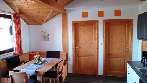 a dining room with a wooden table and chairs at Familie Sattler in Pappenheim