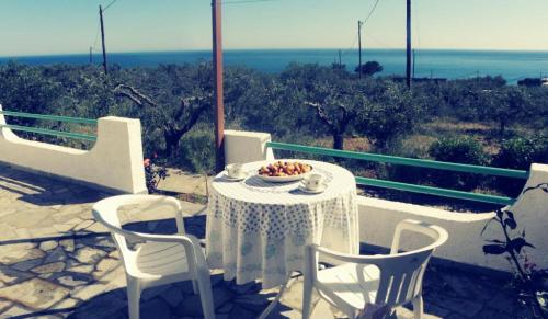a table and chairs with a bowl of fruit on it at Studios Crete in Ferma