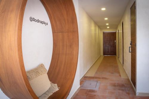 a hallway with a round mirror in a room at Rodina Boutique Hotel in Playa del Carmen