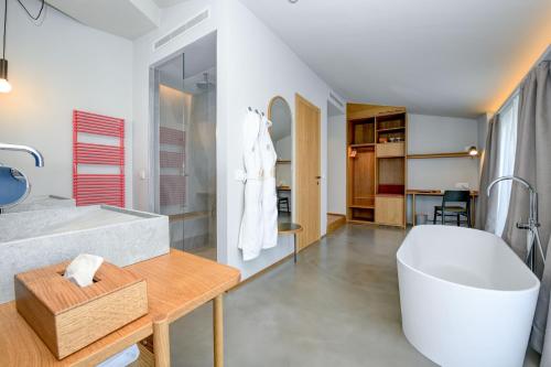 a bathroom with a large tub and a white bath tub at Hotel Flaminia in Sirmione