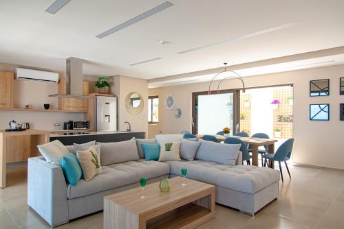 a living room with a couch and a table at Lamar Private Luxury Villas in Marathias