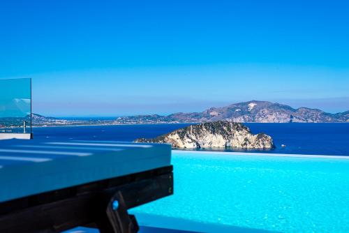 a swimming pool with a view of the ocean at Lamar Private Luxury Villas in Marathias