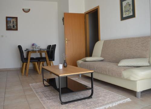 a living room with a couch and a table at Central Apartments Preko in Preko