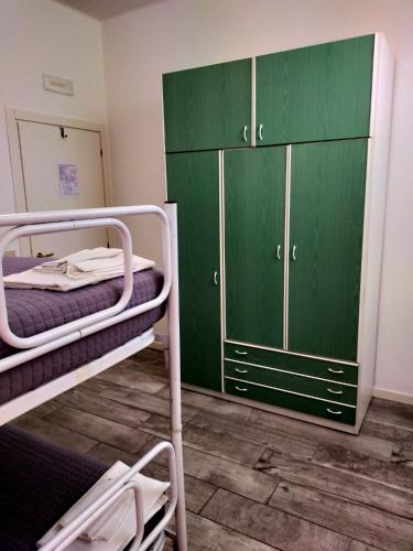 a room with two bunk beds and a green cabinet at Hotel Bellavista in San Marino