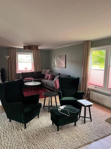 a living room with a couch and chairs and tables at Wunderbares Feriendomizil mit Whirlpool in Sölvesborg