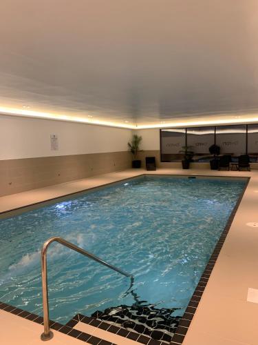 a large swimming pool in a building at 7 Putsborough - Luxury Apartment at Byron Woolacombe, only 4 minute walk to Woolacombe Beach! in Woolacombe
