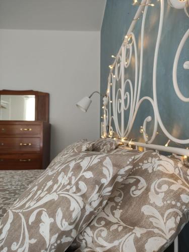 a bed with a metal headboard with lights on it at Corso Umberto - apartment in the Molise hills in Tavenna