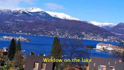 a view of a lake with snow covered mountains at Sirena in Stresa