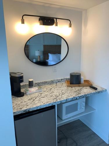 a bathroom counter with a mirror and a sink at Grand View Hotel in York Beach