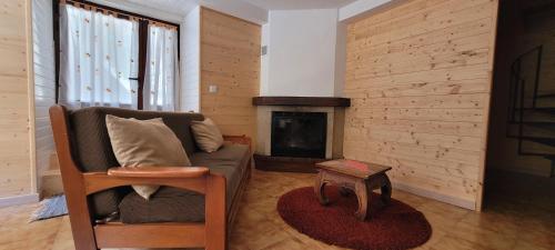 a living room with a couch and a fireplace at Casa do Quinteiro in Arcos de Valdevez